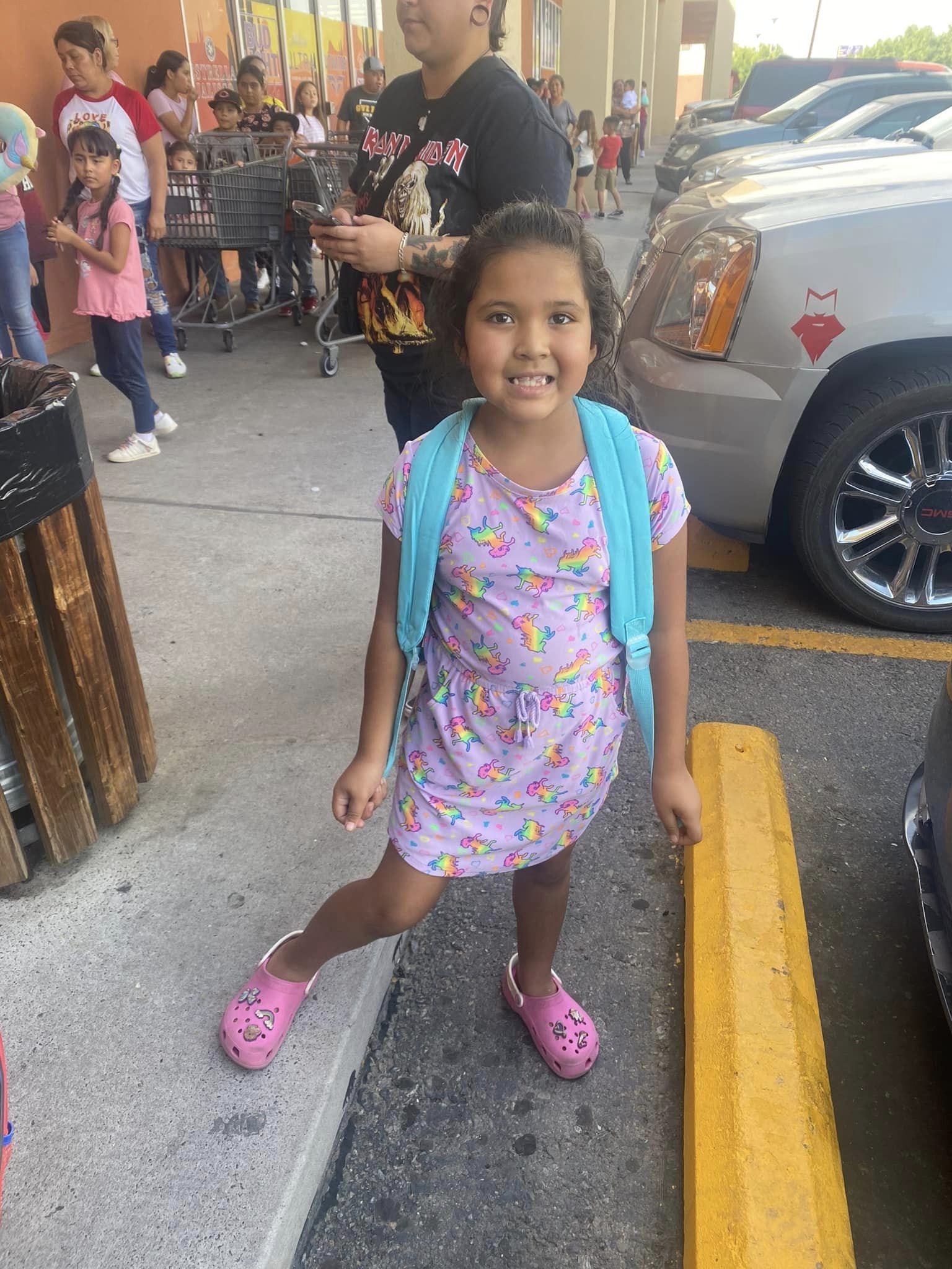 little girl posing with new backpack