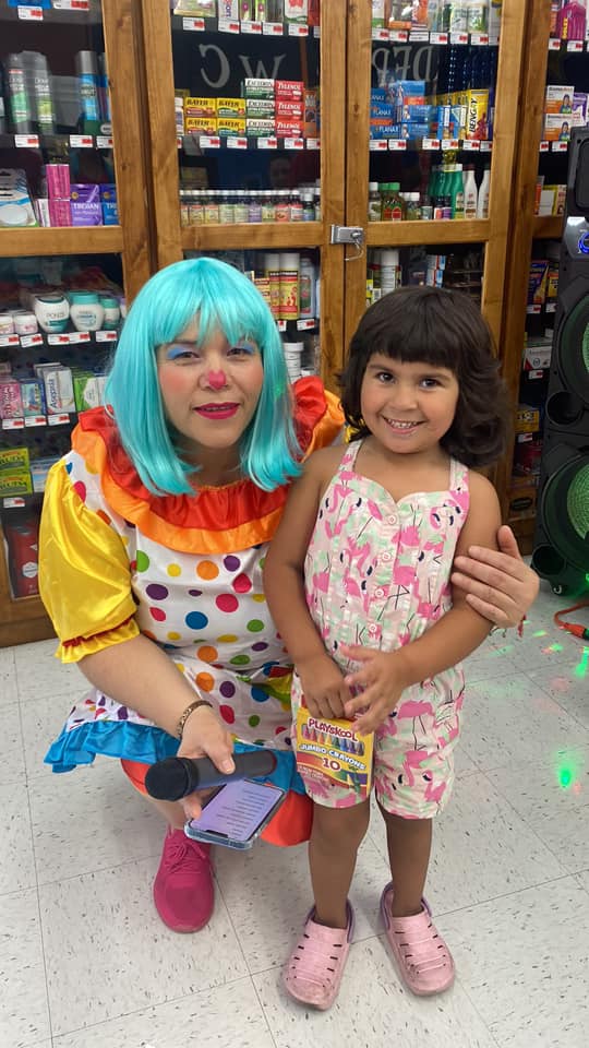 little girl posing with clown